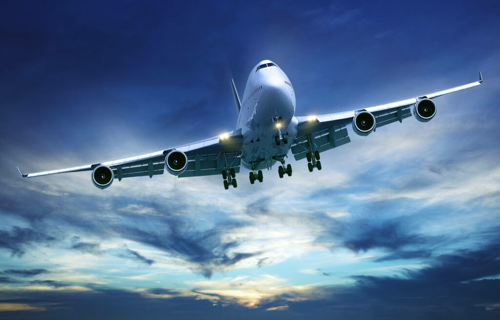 In Flight Majesty: Captivating HD Plane Soars through Enigmatic Blue Sky Wallpaper