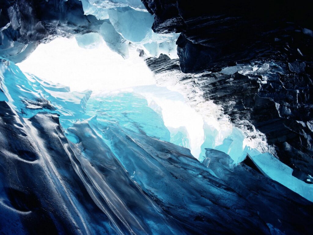 Icy gorge wallpaper with jagged rocks shimmering blue and white under soft natural light