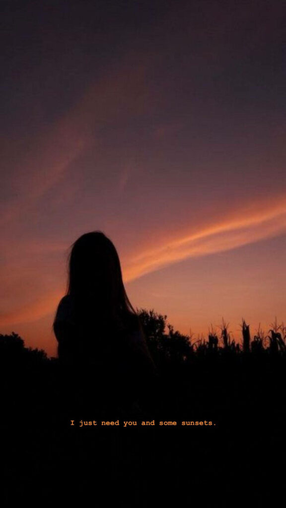 Ethereal Twilight: An Emotive Silhouette Embracing Solace Amidst a Fiery Horizon Wallpaper