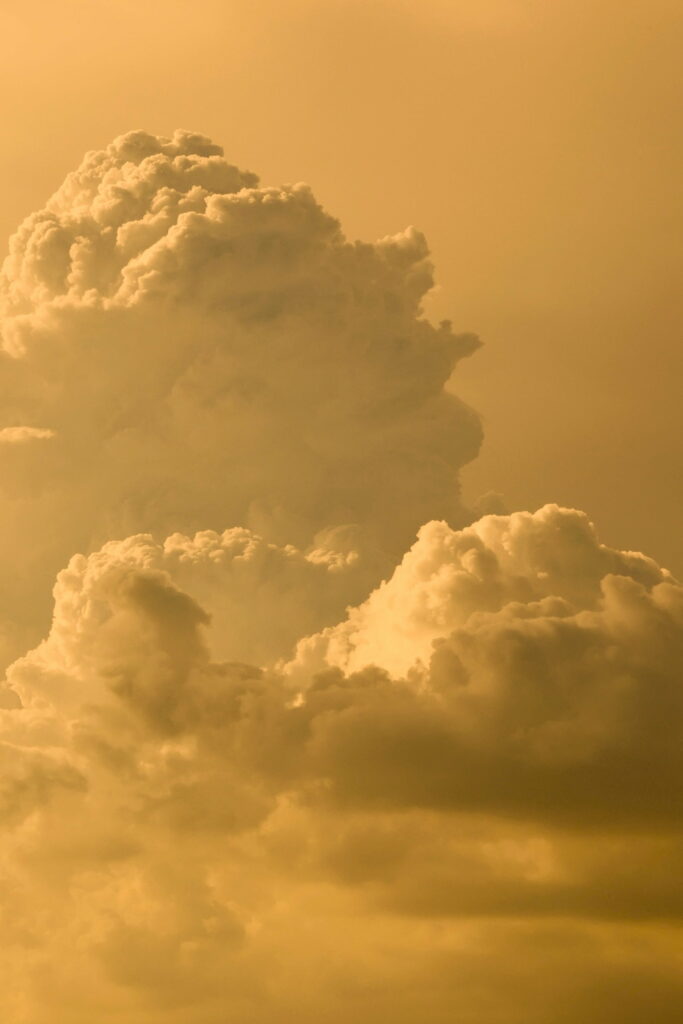 Serene HD Wallpaper: Ethereal Clouds in a Warm Yellow Sky