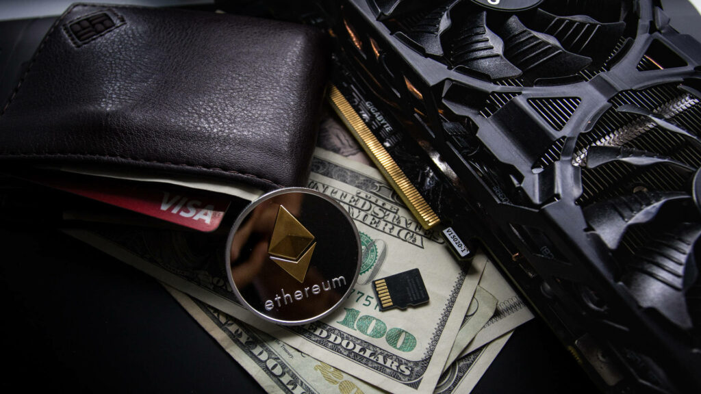 Ethereum coin on US dollars with computer parts leather wallet and credit card digital finance wallpaper