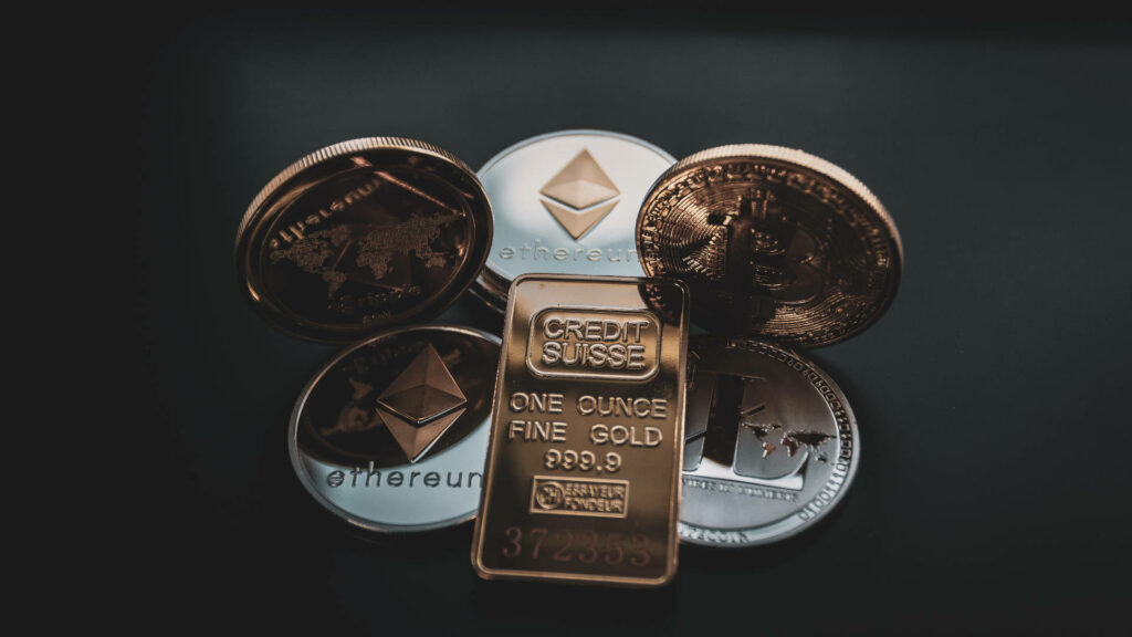 Ethereum coins and gold bar on dark background symbolizing digital and traditional assets blend Wallpaper