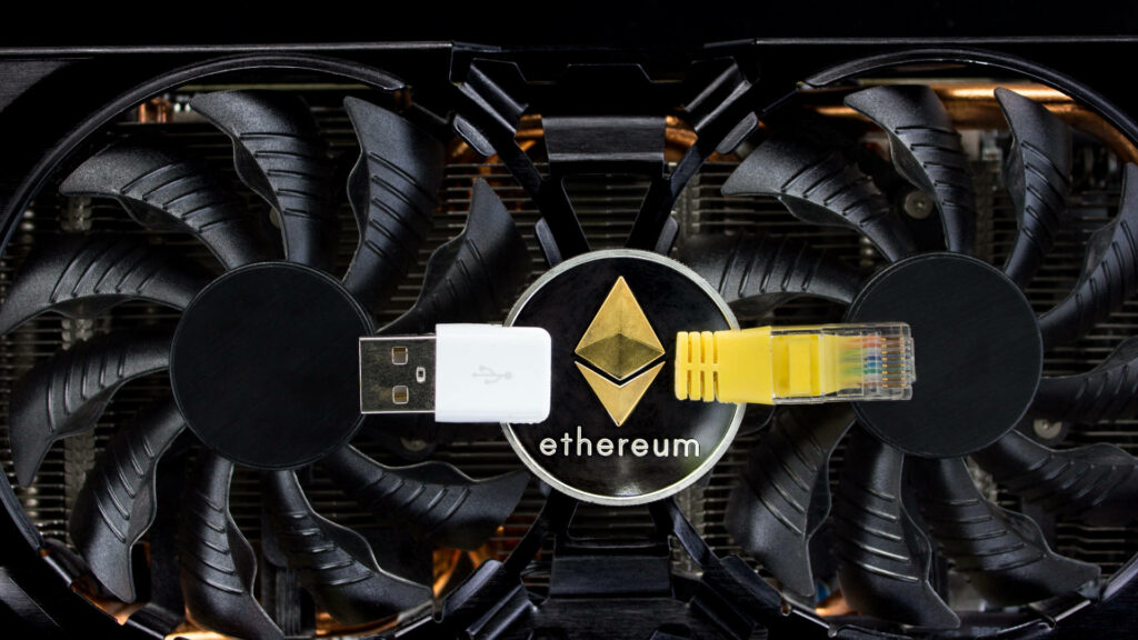 Close-up of dual fan graphics card with Ethereum logo USB drive and network cable blockchain tech Wallpaper