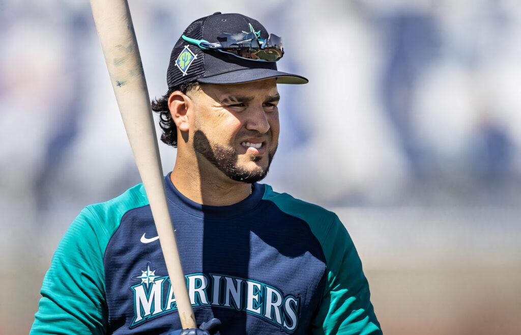 Eugenio Suárez Mariners player in navy teal uniform holding bat ready for game stadium background Wallpaper