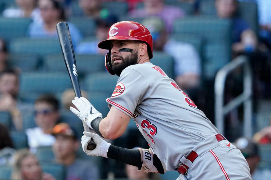 Eugenio Suárez Seattle infielder intensely focused in colorful baseball game with blurred crowd background Wallpaper