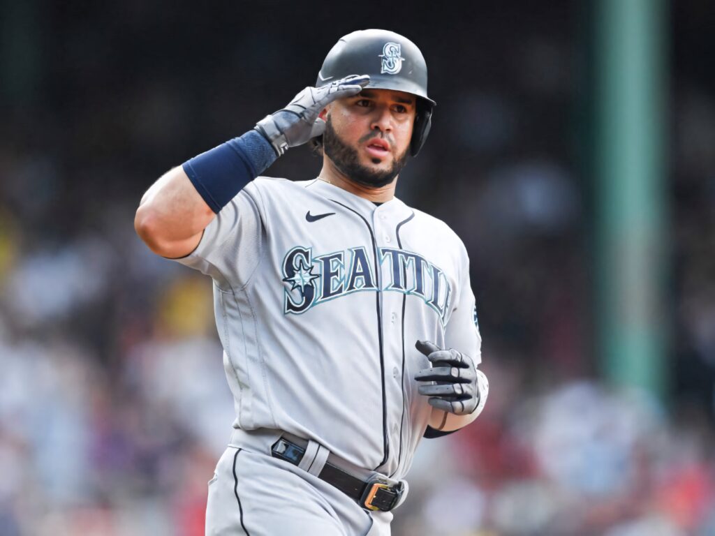 Eugenio Suárez Seattle Mariners salute pose on baseball field vibrant sports celebration wallpaper