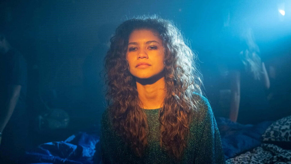 Euphoria Wallpaper: Rue's Moody & Introspective Scene in Dim Light