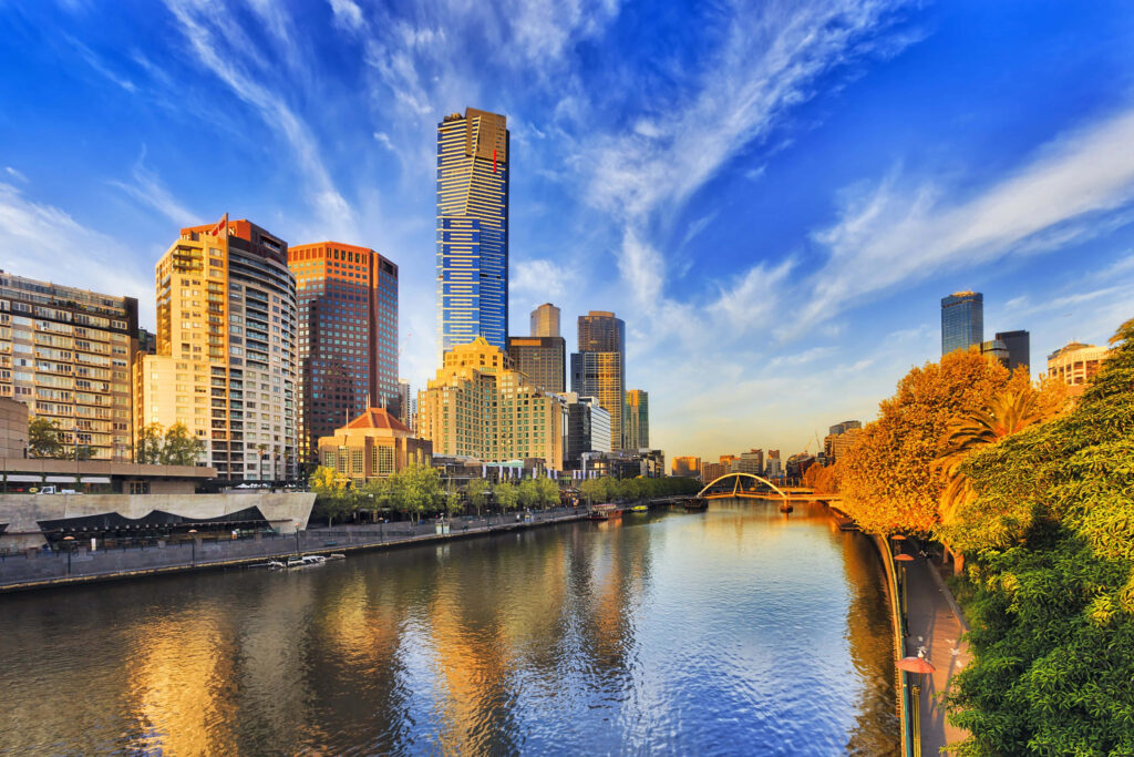 Eureka Tower and Melbourne cityscape with Yarra River under bright blue sky vibrant wallpaper