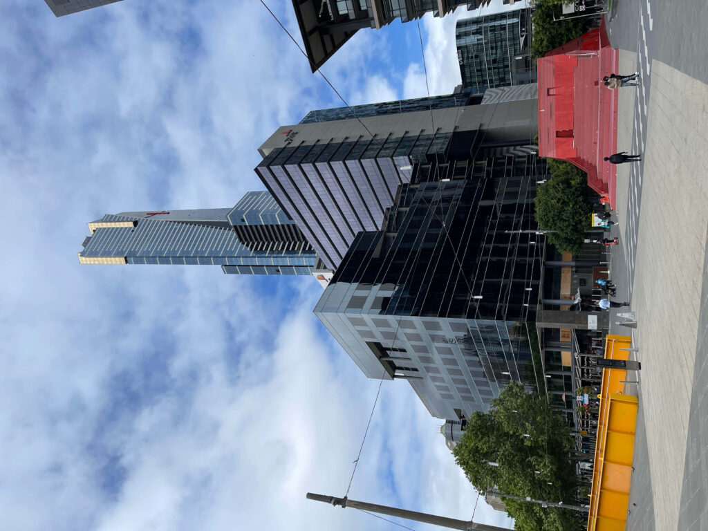 Eureka Tower Melbourne with blue sky modern glass buildings vibrant urban cityscape wallpaper
