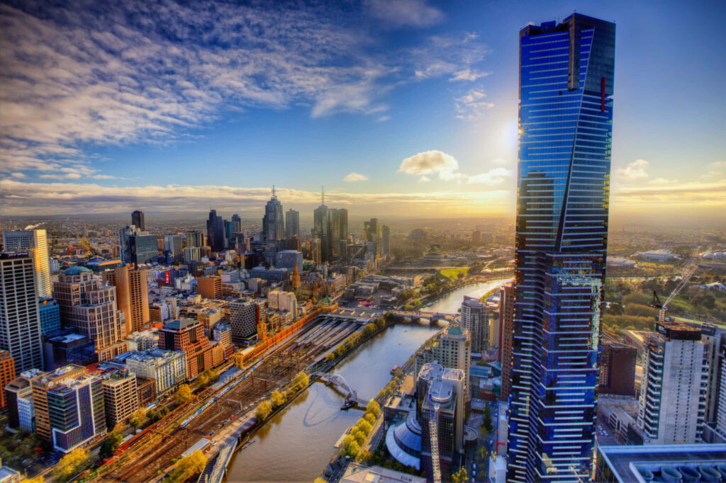 Eureka Tower Melbourne skyline at sunset with river modern skyscrapers vibrant cityscape wallpaper
