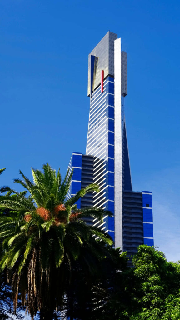 Eureka Tower Melbourne blue silver glass façade vibrant sky palm trees wallpaper background