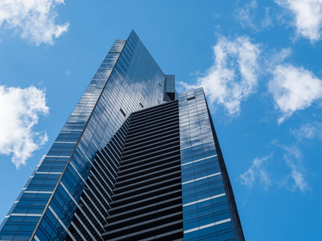Eureka Tower Melbourne low-angle view reflective glass skyscraper blue sky clouds wallpaper