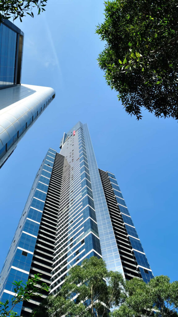 Eureka Tower Melbourne skyscraper with modern architecture blue sky green foliage urban design Wallpaper