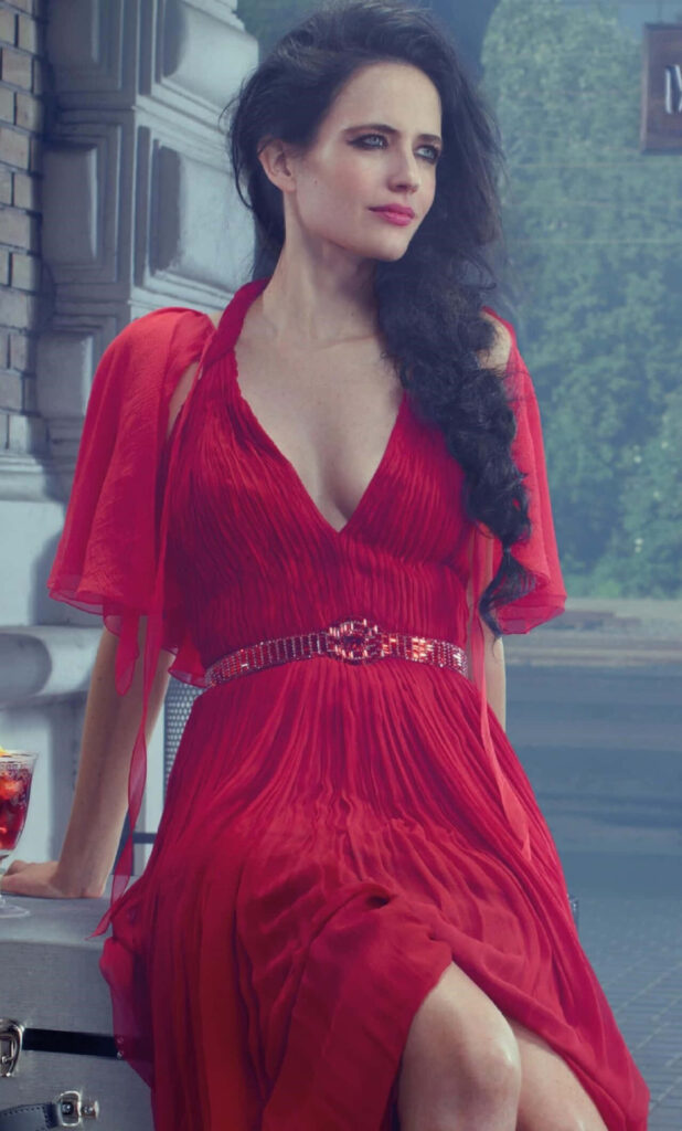 Eva Green in elegant red gown with intense gaze urban background striking wallpaper image