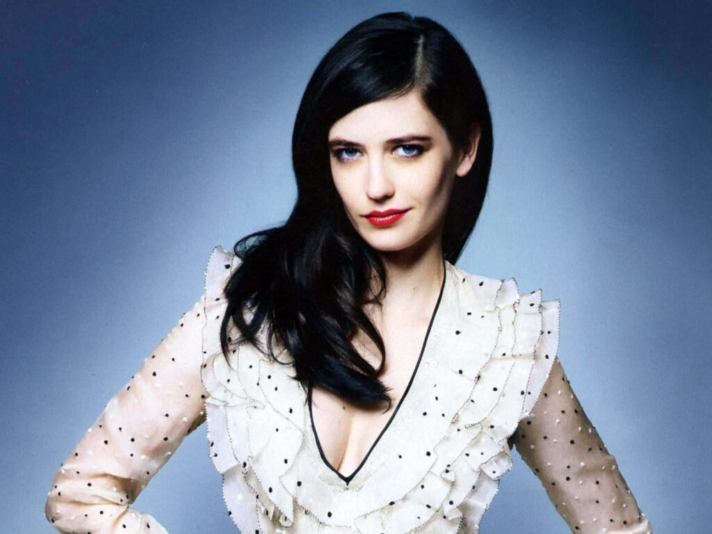 Eva Green in stylish polka dot ruffled top posing gracefully with soft lighting on dark background Wallpaper