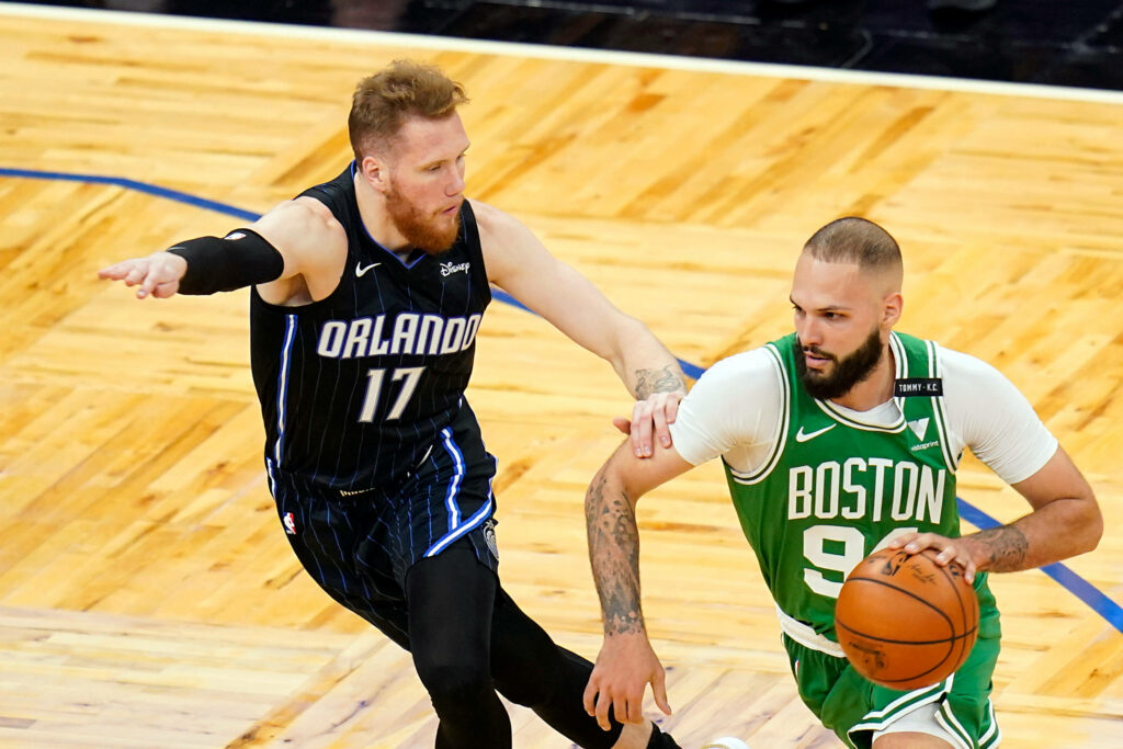 Evan Fournier dribbling Celtics vs Magic NBA action with Ignas Brazdeikis on polished court wallpaper