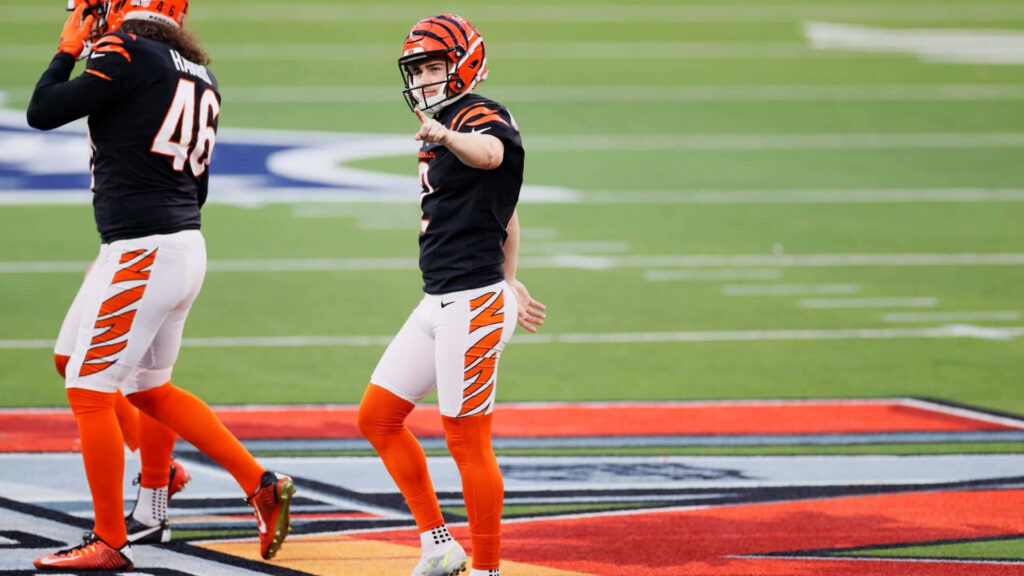 Evan McPherson in Cincinnati Bengals uniform on football field showcasing game day intensity Wallpaper