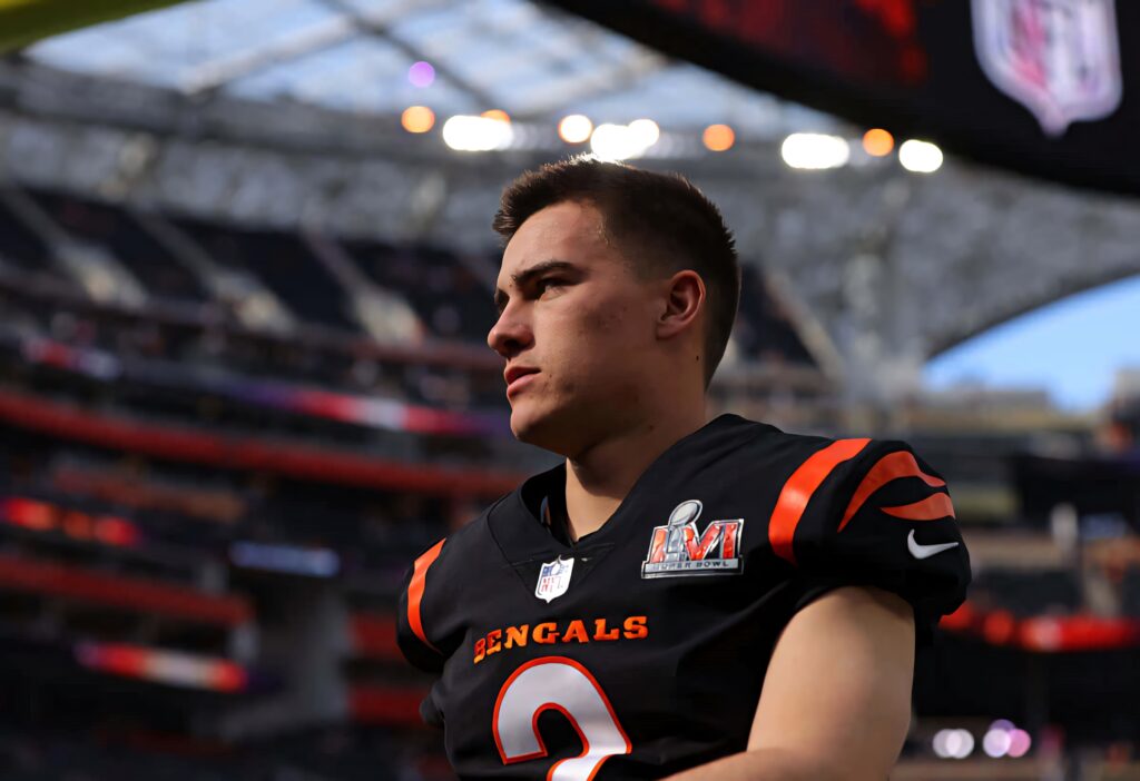 Evan McPherson in Cincinnati Bengals uniform on stadium field with vibrant football game atmosphere Wallpaper
