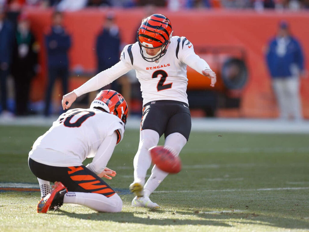 Evan McPherson Cincinnati Bengals kicker mid field goal attempt in white orange NFL uniform wallpaper