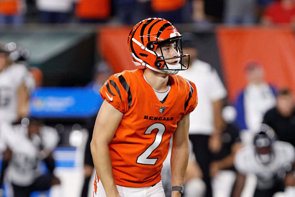Evan McPherson in Cincinnati Bengals orange and black uniform focused on football field Wallpaper