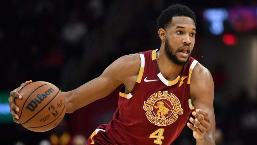 Evan Mobley Cleveland Cavaliers dribbling basketball intense action burgundy gold uniform wallpaper