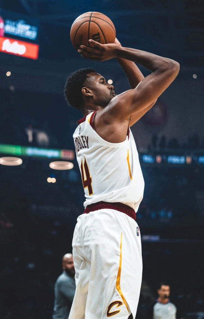 Evan Mobley Cleveland Cavaliers jump shot basketball focused athleticism arena lights wallpaper