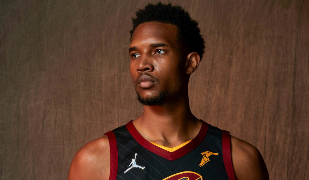 Evan Mobley Cleveland Cavaliers portrait with dramatic lighting and rich maroon gold tones wallpaper