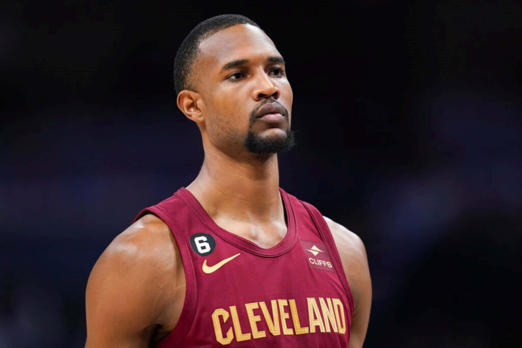 Evan Mobley in Cleveland Cavaliers jersey intense focus dark blurred background wallpaper