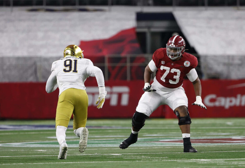 Evan Neal in Action: Stunning Football Skills Wallpaper Background