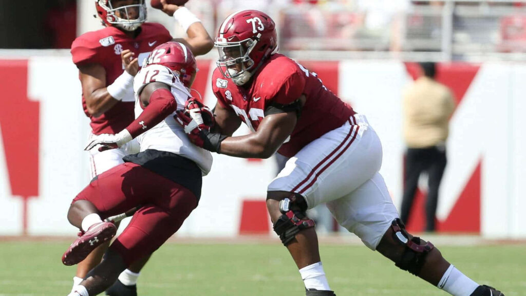 Evan Neal in Action: NFL Star Showcasing Skills - Dynamic Wallpaper