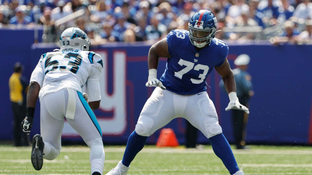 Evan Neal: Offensive Lineman in Action - Football Wallpaper Background