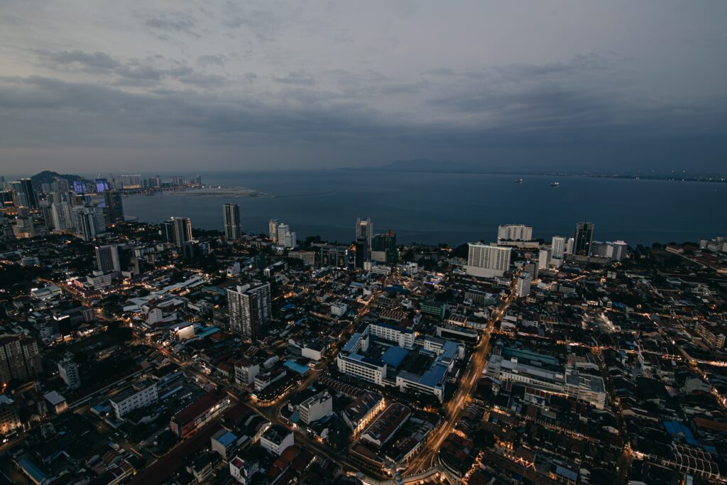 Vibrant Evening Cityscape Wallpaper with Serene Sea & Architecture
