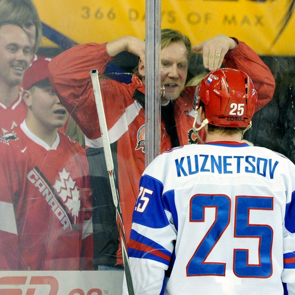 Ice hockey player Evgeny Kuznetsov in Russian jersey number 25 with Canadian fans background Wallpaper
