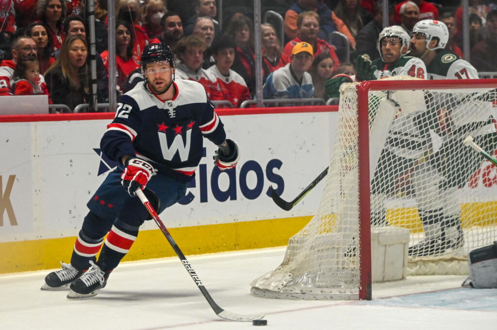 Evgeny Kuznetsov Washington Capitals hockey player in action with vibrant crowd background wallpaper