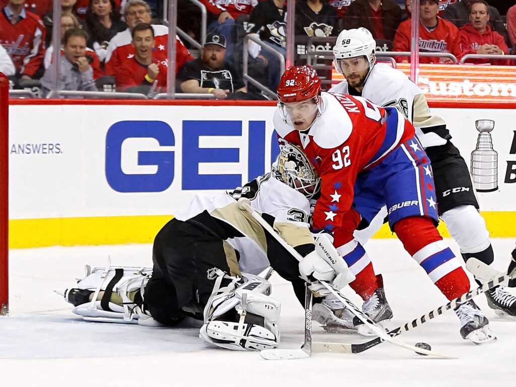 Evgeny Kuznetsov Washington Capitals skates fast against Pittsburgh Penguins in intense NHL game Wallpaper