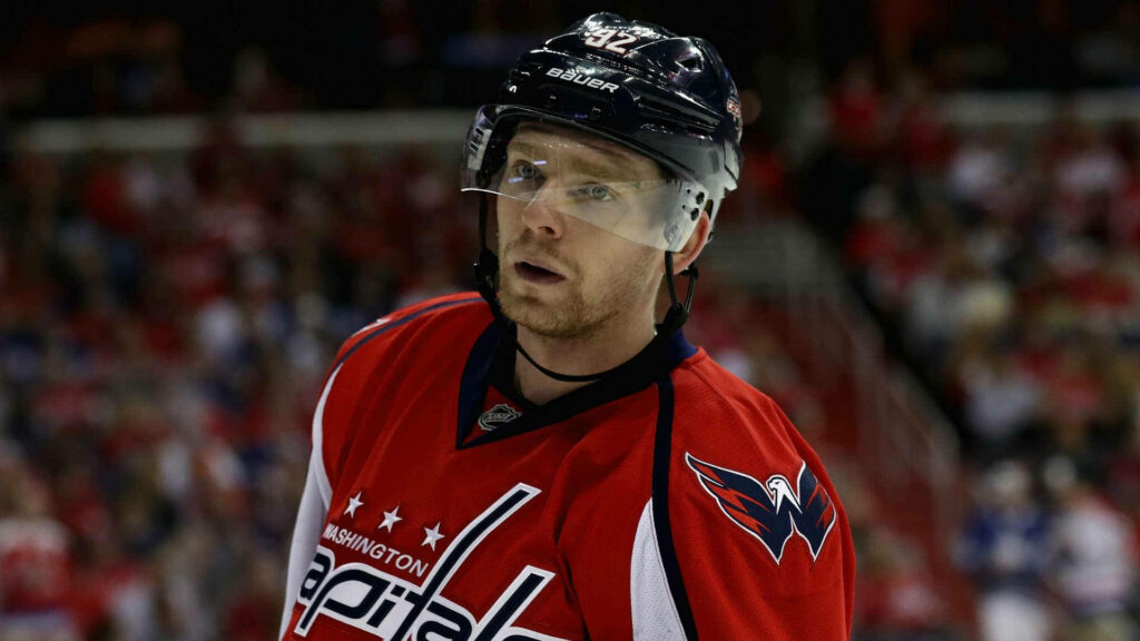 Evgeny Kuznetsov Washington Capitals jersey vibrant crowd intense hockey player wallpaper background