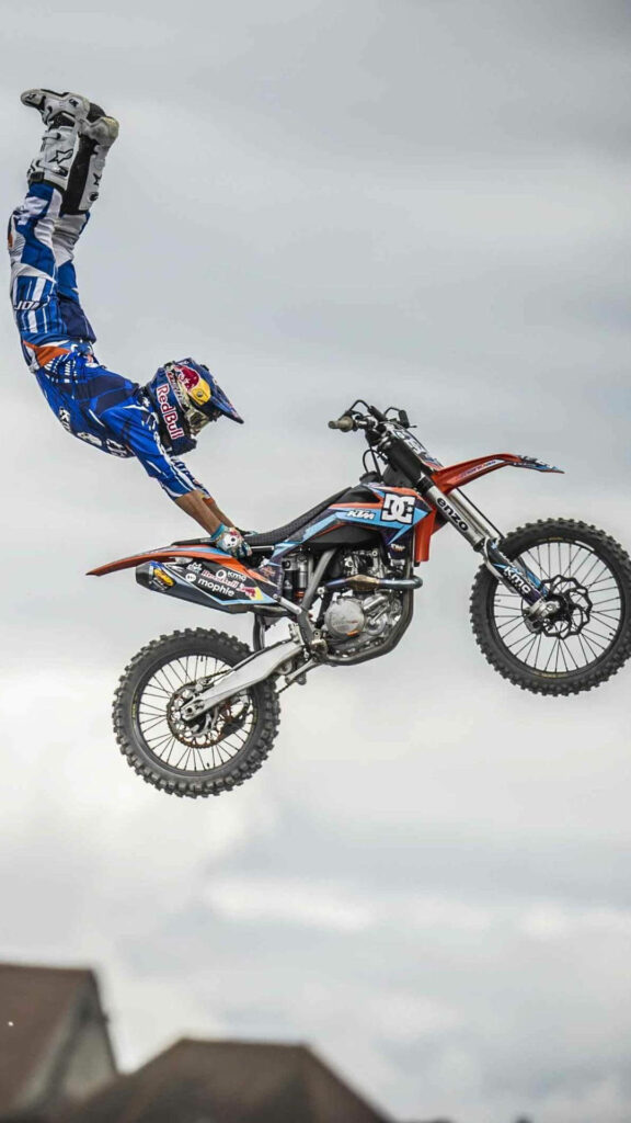 Thrilling Motocross Stunt Wallpaper - Daring Rider in Action