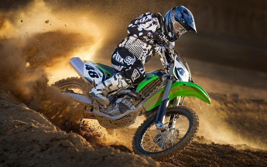Thrilling Motocross Rider on Green Dirt Bike - Dynamic Wallpaper