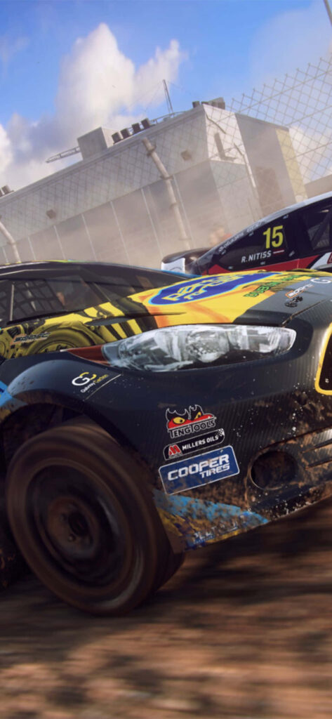Intense Dirt Rally Action: Rally Car Speeding on Gritty Track with Sponsor Logos - Perfect for Racing Fans! Wallpaper