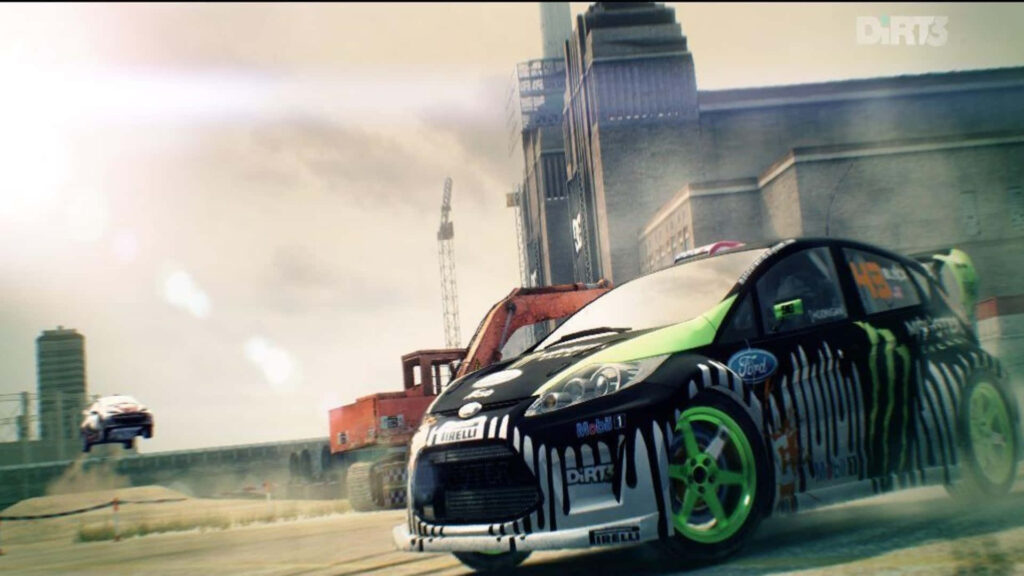 Dirt 3 Rally Car Racing at High Speed in Industrial Setting Wallpaper