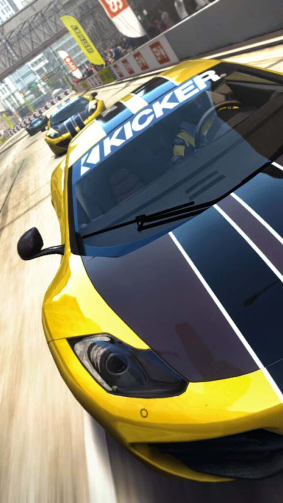 Vibrant yellow Grid Autosport race car speeds down track with KICKER sponsorship logo in dynamic moment Wallpaper