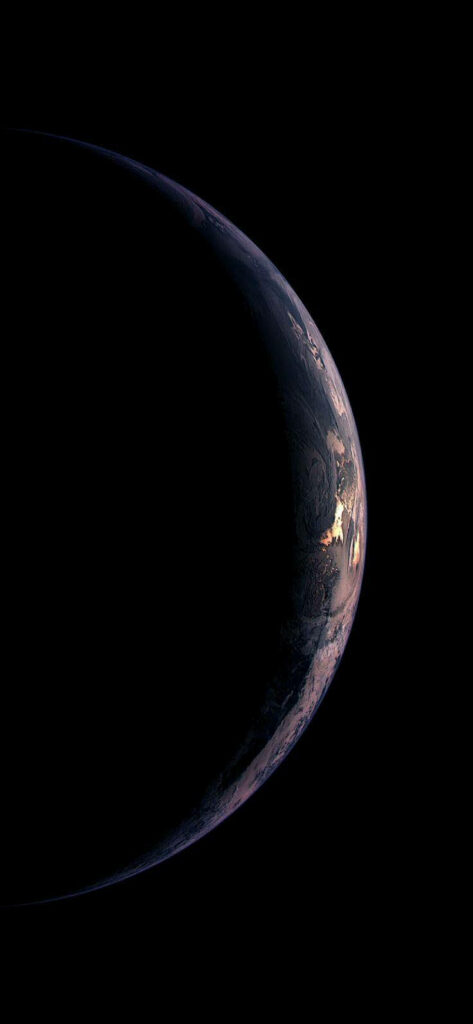 Earth crescent with glowing city lights against dark space curved horizon minimal wallpaper background