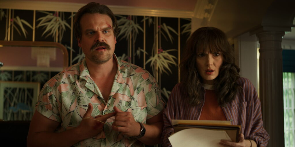 The Enigmatic duo of David Harbour and Winona Ryder grace this captivating Stranger Things QHD Wallpaper