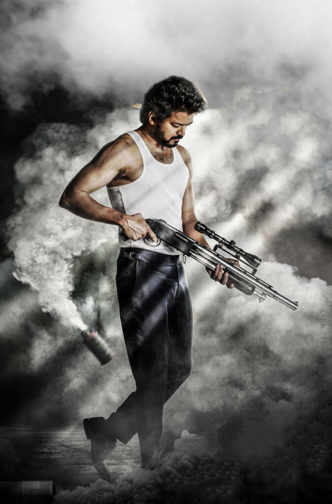 Explosive Coolness: Master Vijay Wields Guns and Bombs in HD Graphics Wallpaper