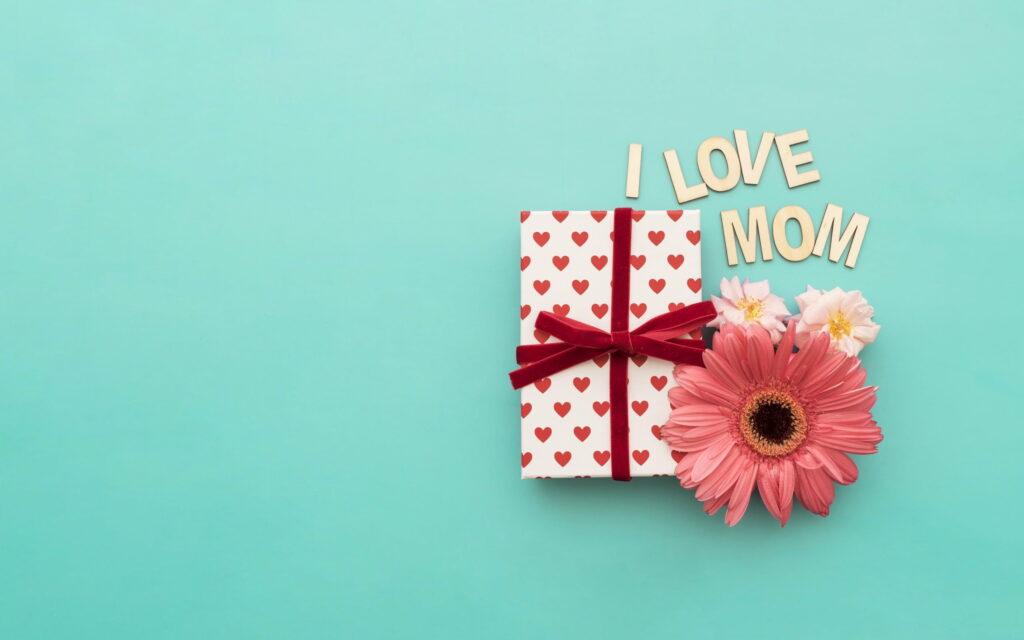 Expressing Love on Mother's Day: Gifted Pink Gerberas Adorn This Charming QHD Wallpaper Background