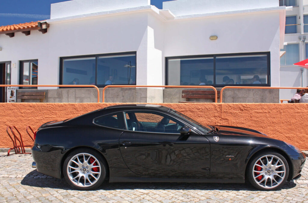 Marvel at the Captivating Performance of the Ferrari 612 Scaglietti: A Mesmerizing Display of Elegance and Power on the Open Road Wallpaper