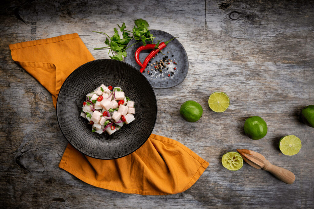 Vibrant Ceviche Wallpaper: Exquisite Bowl on Rustic Wood Background