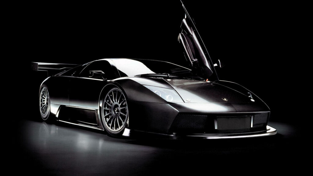Lamborghini Gallardo with Opened Flap Door Shines in Spotlight against a Dark Backdrop Wallpaper