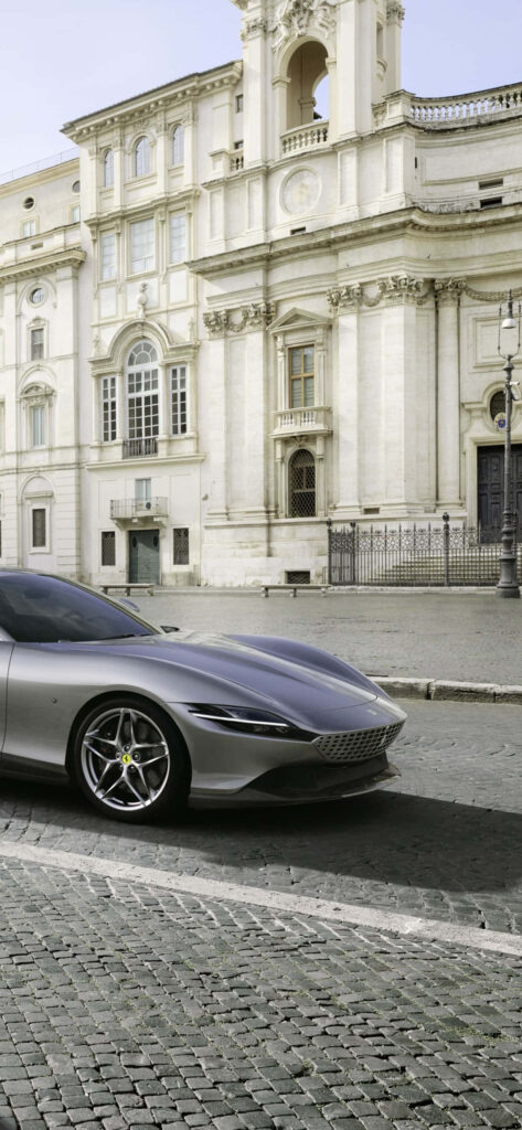 Elegant Grey Ferrari Roma Steals the Spotlight against Max Ferrari's Mesmerizing Backdrop Wallpaper