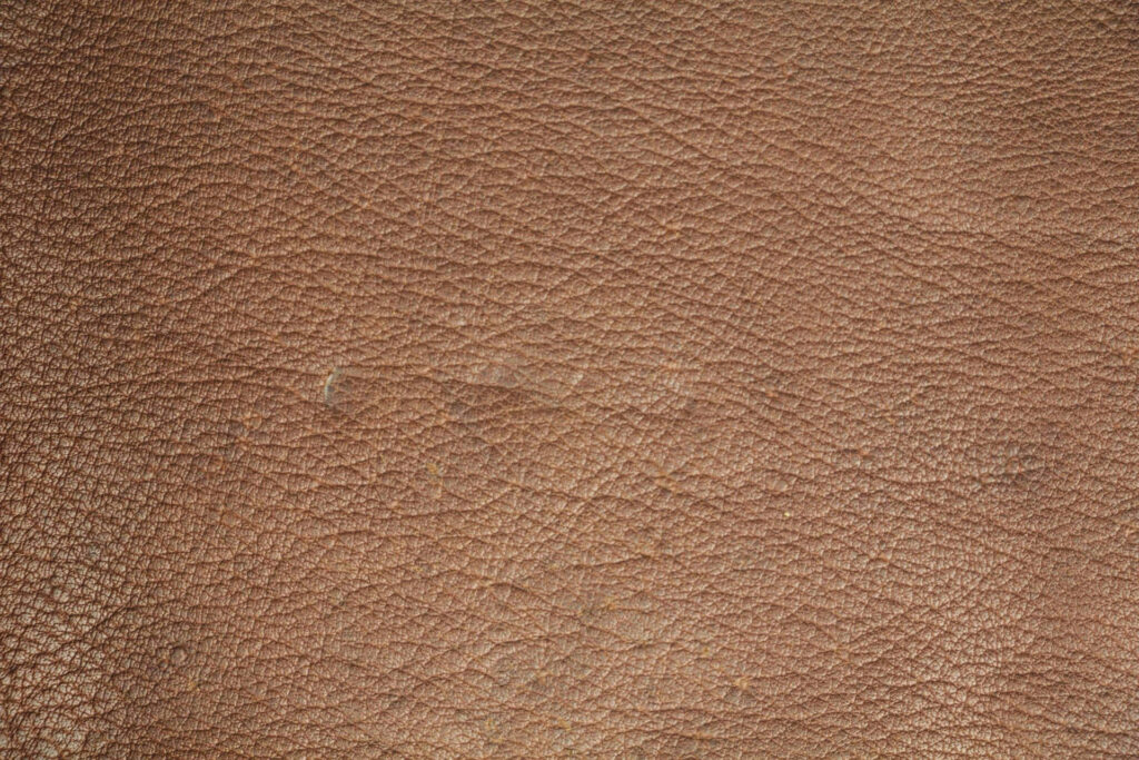 Animal Skin Abstract: The Exquisite Light Brown Leather Texture with Intricate Embedded Lines Wallpaper